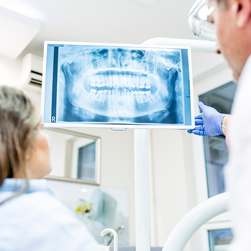 dentist and patient looking at dental scans