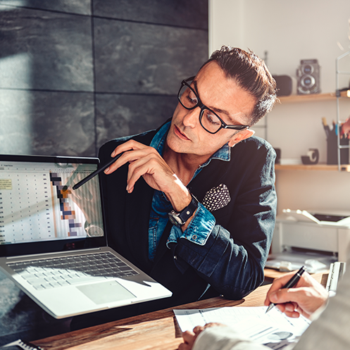 man pointing at data on computer